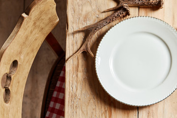 Empty white plate with deer antlers