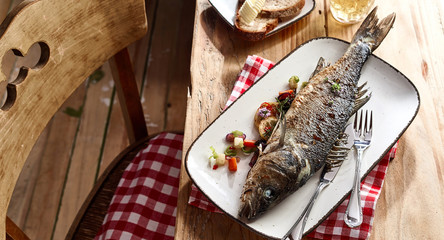 Whole grilled sea bass served on a platter