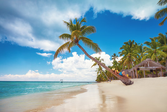Free happy woman enjoying tropical Caribbean island Saona, Dominican Republic. Summer vacation and healthy living concept.
