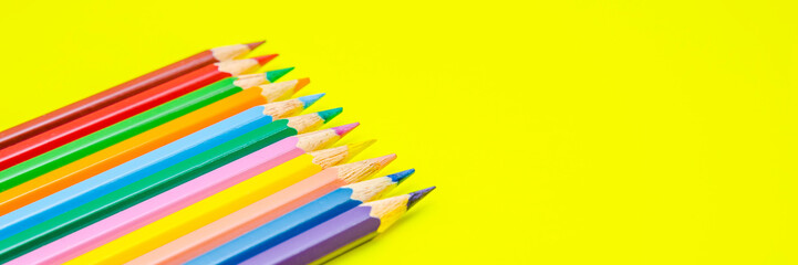 Pencils on yellow background, school stationery, back to school, coloring pencil, close up pencils background