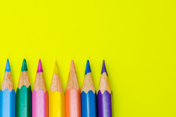 Pencils on yellow background, school stationery, back to school, coloring pencil, close up pencils background