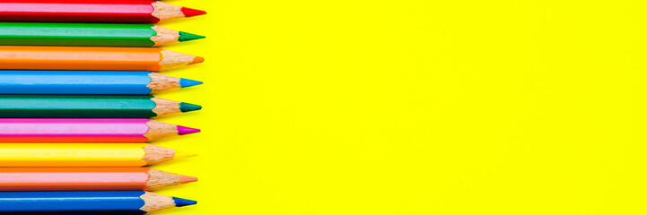 Pencils on yellow background, school stationery