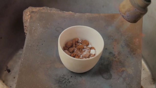 The process of melting gold for making jewelry.