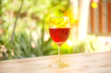 Fresh red grape juice and grapes on wooden garden table, refreshing organic antioxidant beverage 