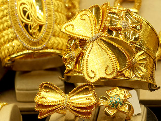 Beautiful gold rings and bracelets on stands close up