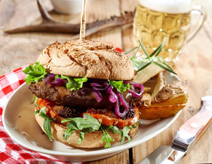 Gourmet wild venison burger trimmed with greens