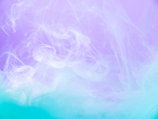 Fototapeta premium Multicolor abstract background. Close up view. Blurred background. Lilac and turquoise paint dissolving into water, abstract pattern. Acrylic clouds mixing with liquid. Abstract art