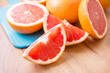 Naklejka na ściany i meble Closeup of sliced juicy grapefruit pieces