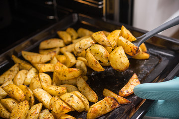 Golden oven-baked potatoes with oil and spices