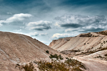 white limestone quarry on a background of blue sky with clouds