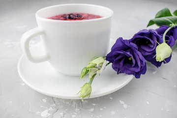 Mixture herbal floral tea with petals, dry berries and fruits. healthy drink. Hot fruit, healthy tea in a white mug