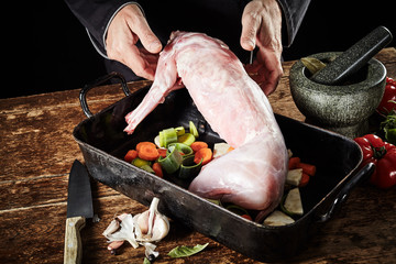 Chef preparing a skinned cleaned wild rabbit