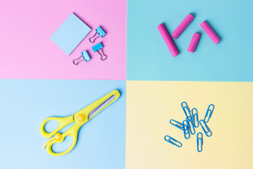 Stationery on blue and yellow background. Back to school concept.