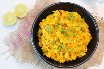 Dal khichadi or Masala Khichdi is a Tasty Indian recipe made of mixed Lentils & rice combined with onions, garlic, tomatoes, Carrots, Peas, cauliflower and beans. Served with Curd or Yogurt & lemon 