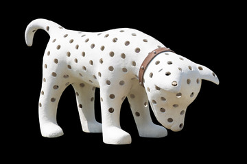 the white dog has a hole in the body on black background isolate