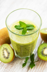 Glass of kiwi smoothie with fresh fruits