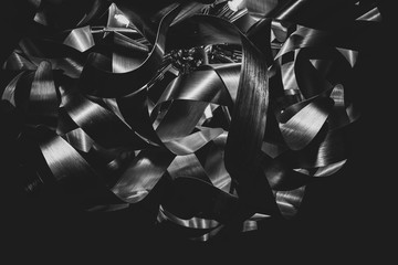 Curved metal stripes chandelier closeup. Creative metal lampshade. Black and white futuristic...