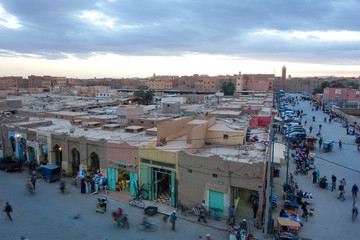 Rissani, Morocco - March 21st, 2019: A view down onto the main street with busy locals during sunset.