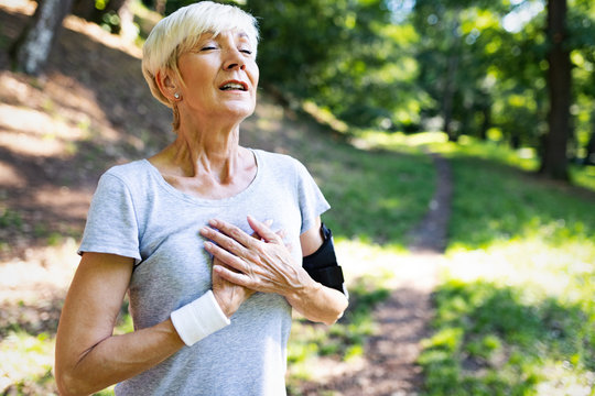 Mature Woman Exercising Outdoors To Prevent Cardiovascular Diseases And Heart Attack
