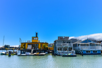House boats floating on water on a sunny day in Sausalito, San Francisco bay, USA