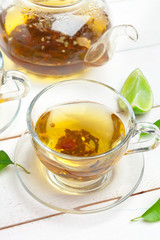 teapot and cups of tea on a white wooden background