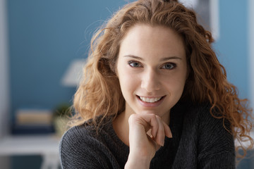 Beautiful curly young woman posing at home