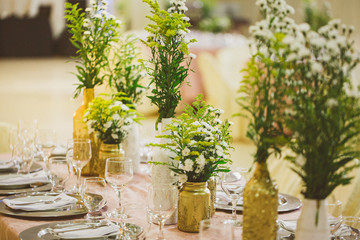 Table decorated for wedding event. Colors golden and white.