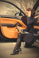 woman sitting on the threshold of the car