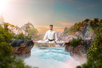 Martial arts master in kimonodo sitting on splits