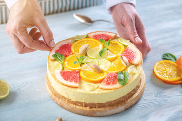 Raw citrus cake with grapefruit, orange, lime and lemon with nuts and mint. Healthy fresh summer dessert