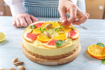 Raw citrus cake with grapefruit, orange, lime and lemon with nuts and mint. Healthy fresh summer dessert