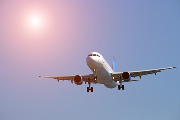 A passenger plane flies on a blue sky