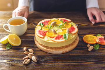 Obraz na płótnie Canvas Raw citrus cake with grapefruit, orange, lime and lemon. Cooking healthy summer vegan dessert with vegetable ingredients
