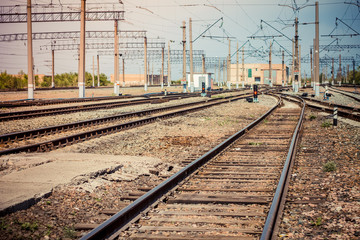Fototapeta na wymiar railway tracks go beyond the horizon on a clear sunny day, a lot of wires upstairs