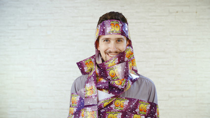 Man wrapped in 30 year happy birthday tape