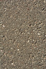 asphalt surface with sand and small pebbles