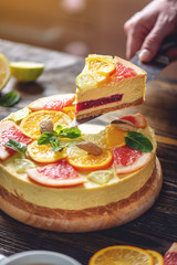A piece of raw citrus cake with grapefruit, orange, lime and lemon. Cooking healthy summer vegan dessert