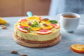 Raw citrus cake with grapefruit, orange, lime and lemon with nuts and mint. Fresh summer dessert. Gluten free vegan food