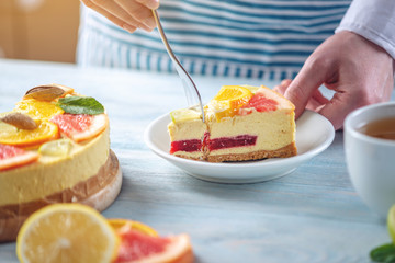 Piece of raw citrus cake with grapefruit, orange, lime and lemon. Cooking at home healthy summer vegan dessert