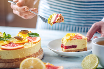 Piece of raw citrus cake with grapefruit, orange, lime and lemon. Cooking at home healthy summer vegan dessert