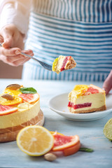 Piece of raw citrus cake with grapefruit, orange, lime and lemon. Cooking at home healthy summer vegan dessert