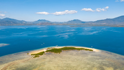 The island of white sand with mangroves. The sea landscape of Honda Bay, view from above. sand bar on coral reefs, Palawan, Philippines.Tropical island with forest on a coral reef, top view.