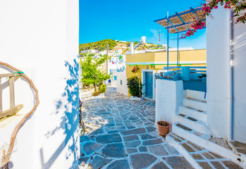 Quiet traditional greek street with white houses