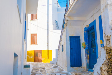 Narrow street with traditional rustic greek houses in the village on Island of Paros, Greece
