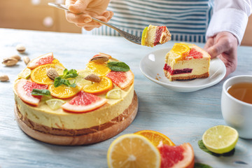 Raw citrus cake with grapefruit, orange, lime and lemon with nuts and mint. Cooking healthy fresh summer vegan dessert