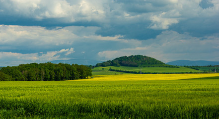 Fototapeta premium Knorr-Berg hill near Dittersbach a.d. Eigen as seen from Bernstadt a.d. Eigen on a cloudy day - May 21st 2019 Saxony/Germany