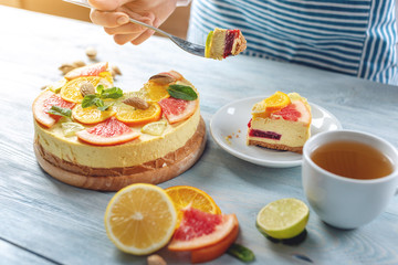 Raw citrus cake with grapefruit, orange, lime and lemon with nuts and mint. Cooking healthy fresh summer vegan dessert