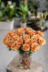 Caramel color, tofi roses in a glass vase. Beautiful rose flower for catalog or online store. Floral shop concept . Beautiful fresh cut bouquet. Flowers delivery