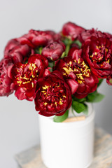 Red peonies in a metal vase. Beautiful peony flower for catalog or online store. Floral shop concept . Beautiful fresh cut bouquet. Flowers delivery