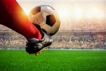 red soccer player kicking ball action in the stadium - obrazy, fototapety, plakaty